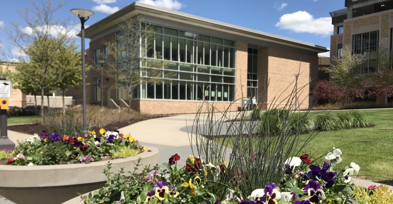 Metro State Student Center seen through flowers in planters
