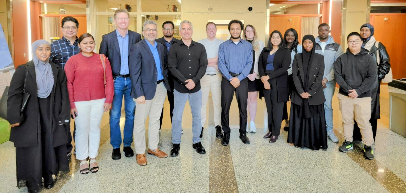A group of students and faculty pose for a picture with Ronald Gula of Gula Tech Adventures