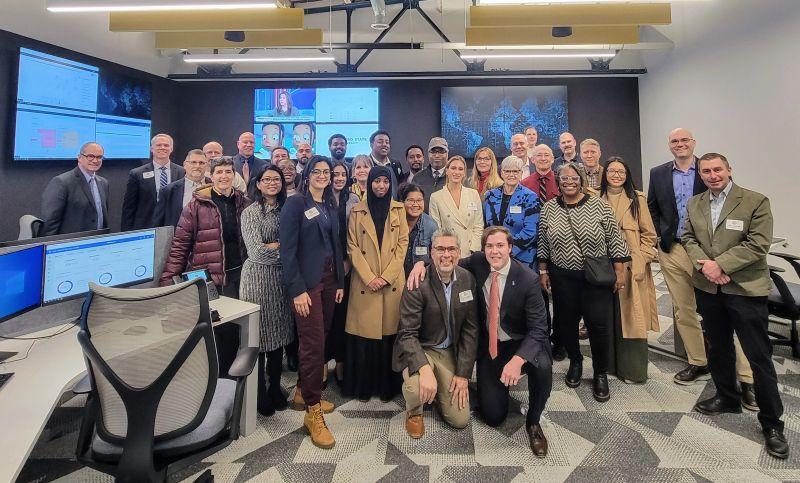 a group of people pose for a picture in Metro State's Security Operations Center